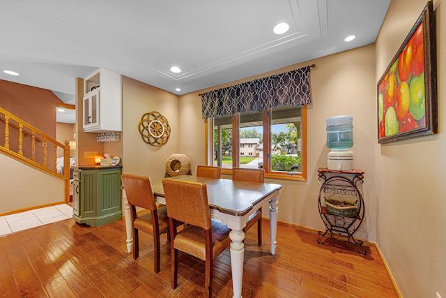 1525 21st Ave NW, Faribault, MN 55021 - dining area featuring hardwood / wood-style floors, recessed lighting, baseboards, and stairs