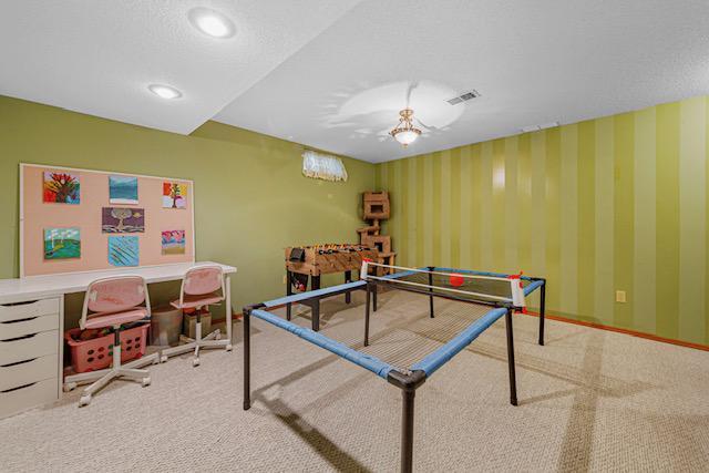 1525 21st Ave NW, Faribault, MN 55021 - recreation room with carpet floors, wallpapered walls, and baseboards