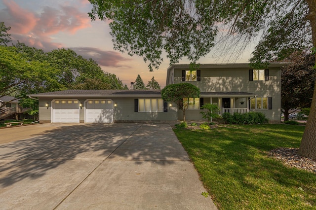 1525 21st Ave NW, Faribault, MN 55021 - traditional-style home with covered porch, a garage, driveway, and a lawn