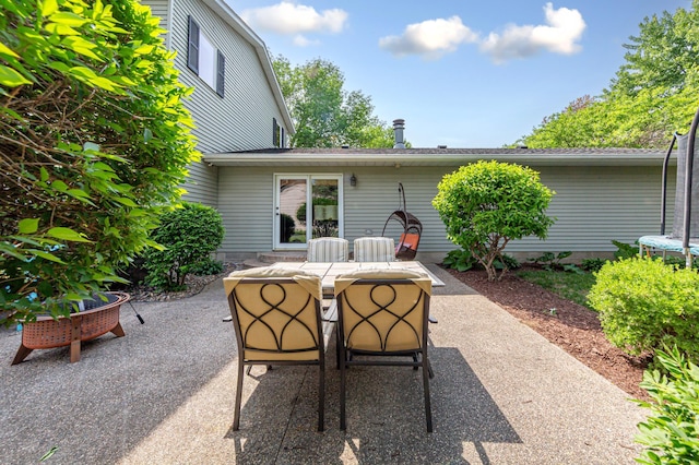 1525 21st Ave NW, Faribault, MN 55021 - view of patio featuring outdoor dining space and a trampoline