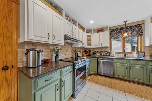 1525 21st Ave NW, Faribault, MN 55021 - kitchen featuring stainless steel appliances, green cabinetry, under cabinet range hood, white cabinetry, and tasteful backsplash