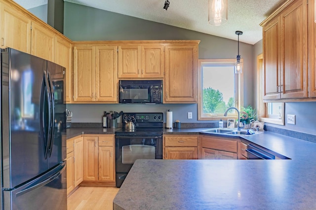 1918 Silver St, Waconia, MN 55387 - kitchen featuring black appliances, vaulted ceiling, a sink, dark countertops, and pendant lighting