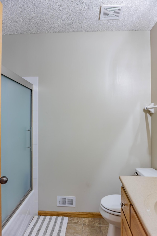 1918 Silver St, Waconia, MN 55387 - full bathroom featuring a textured ceiling, toilet, vanity, baseboards, and combined bath / shower with glass door