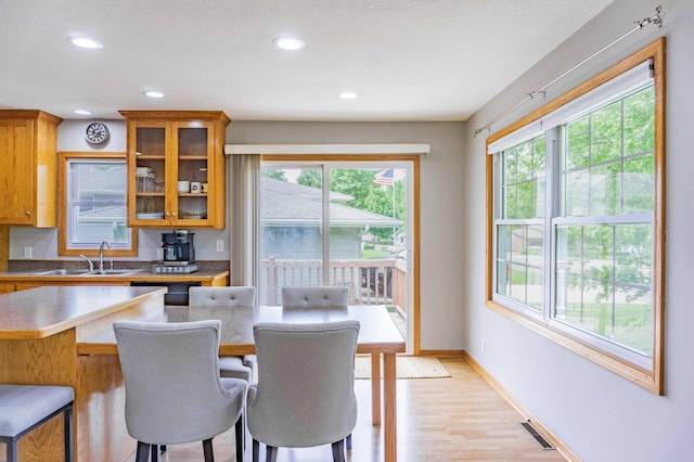 319 Casper Cir, Norwood Young America, MN 55368 - kitchen featuring a sink, a breakfast bar, brown cabinets, healthy amount of natural light, and recessed lighting