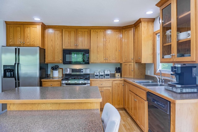 319 Casper Cir, Norwood Young America, MN 55368 - kitchen featuring black appliances, a sink, a center island, glass insert cabinets, and light wood-style flooring
