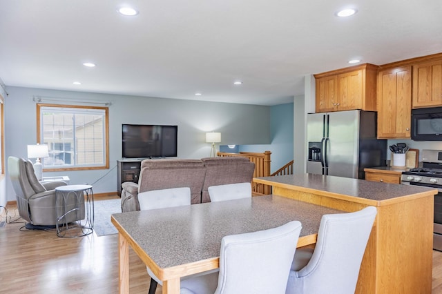 319 Casper Cir, Norwood Young America, MN 55368 - kitchen with stainless steel appliances, recessed lighting, light wood-style floors, a center island, and a kitchen breakfast bar