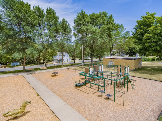 319 Casper Cir, Norwood Young America, MN 55368 - community play area featuring a lawn and view of wooded area