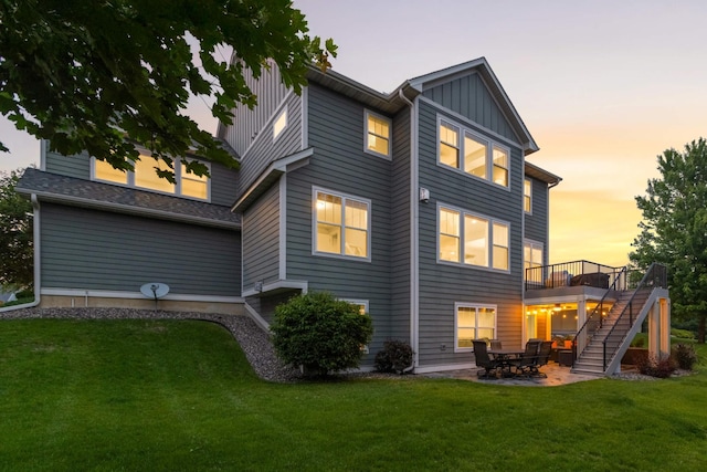 16632 Early Dawn Trl, Lakeville, MN 55044 - back of property featuring stairs, board and batten siding, a yard, a wooden deck, and a patio