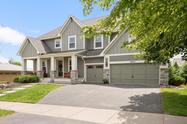 16632 Early Dawn Trl, Lakeville, MN 55044 - craftsman-style house with board and batten siding, covered porch, stone siding, and a garage