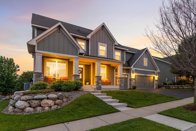 16632 Early Dawn Trl, Lakeville, MN 55044 - craftsman-style house with board and batten siding, covered porch, stone siding, driveway, and a yard