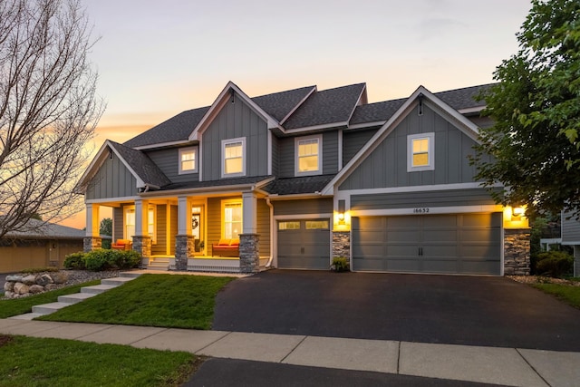 16632 Early Dawn Trl, Lakeville, MN 55044 - craftsman house featuring board and batten siding, stone siding, asphalt driveway, and a garage