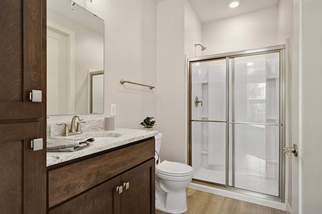 16632 Early Dawn Trl, Lakeville, MN 55044 - full bathroom with vanity, a shower stall, toilet, and wood finished floors