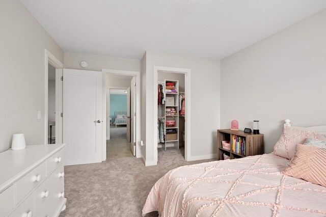 16632 Early Dawn Trl, Lakeville, MN 55044 - bedroom featuring light carpet, a walk in closet, a closet, and baseboards