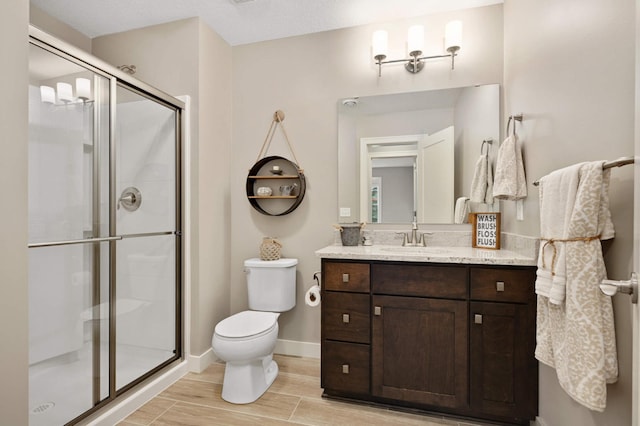 16632 Early Dawn Trl, Lakeville, MN 55044 - full bathroom featuring toilet, vanity, a shower stall, and wood finish floors