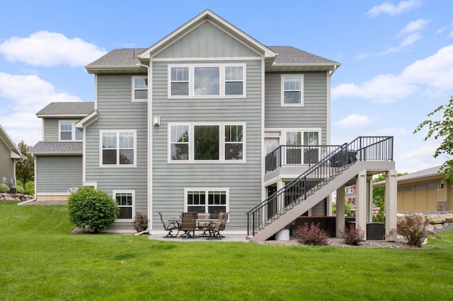 16632 Early Dawn Trl, Lakeville, MN 55044 - rear view of house featuring stairs, a lawn, board and batten siding, a wooden deck, and a patio