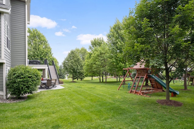 16632 Early Dawn Trl, Lakeville, MN 55044 - view of green lawn with a playground, stairs, and a patio