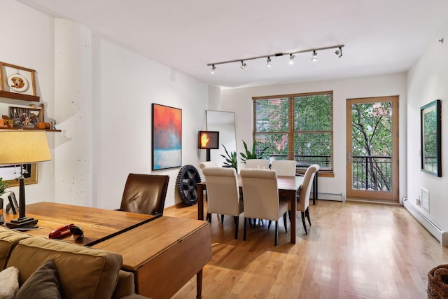 401 2nd St Unit 208, Minneapolis, MN 55401 - dining area featuring light wood-style floors and a baseboard heating unit