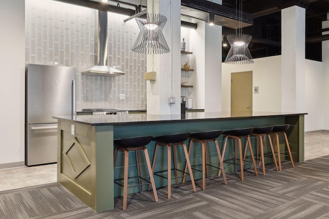 401 2nd St Unit 208, Minneapolis, MN 55401 - kitchen with freestanding refrigerator, wall chimney exhaust hood, carpet floors, dark countertops, and baseboards