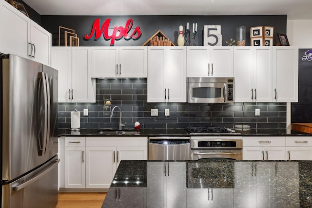 401 2nd St Unit 208, Minneapolis, MN 55401 - kitchen with stainless steel appliances, white cabinetry, and dark stone counters