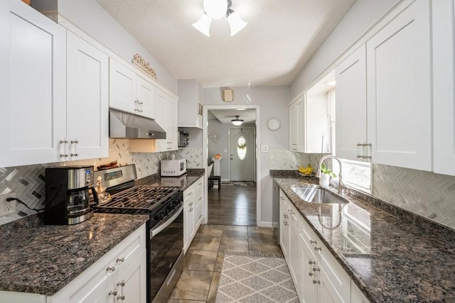 2575 Quebec Ave S, Saint Louis Park, MN 55426 - kitchen featuring gas range, a sink, under cabinet range hood, white microwave, and white cabinetry