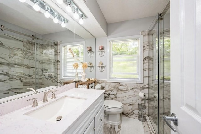 2575 Quebec Ave S, Saint Louis Park, MN 55426 - full bath with a marble finish shower, vanity, tile walls, and toilet