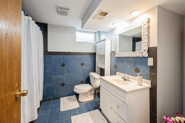 2575 Quebec Ave S, Saint Louis Park, MN 55426 - bathroom featuring tile walls, tile patterned flooring, toilet, vanity, and a shower with shower curtain
