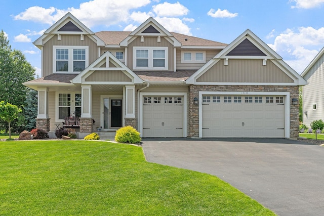 14143 Ailesbury Ave, Rosemount, MN 55068 - craftsman house with stone siding, asphalt driveway, a front lawn, board and batten siding, and roof with shingles
