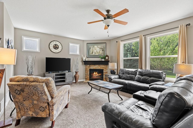 14143 Ailesbury Ave, Rosemount, MN 55068 - living room featuring carpet floors, a ceiling fan, and a stone fireplace
