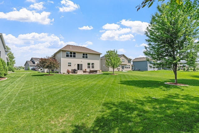 14143 Ailesbury Ave, Rosemount, MN 55068 - rear view of property featuring a patio, a yard, and a residential view