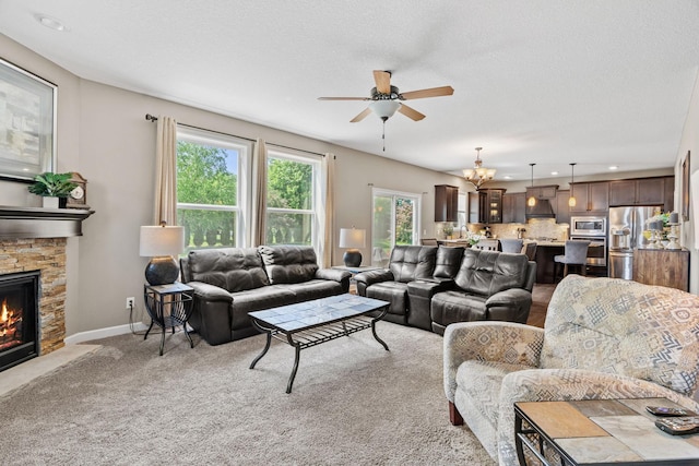 14143 Ailesbury Ave, Rosemount, MN 55068 - living area with a ceiling fan, a stone fireplace, light colored carpet, and recessed lighting