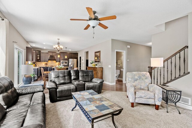 14143 Ailesbury Ave, Rosemount, MN 55068 - living room featuring a chandelier, a ceiling fan, stairs, and wood finished floors