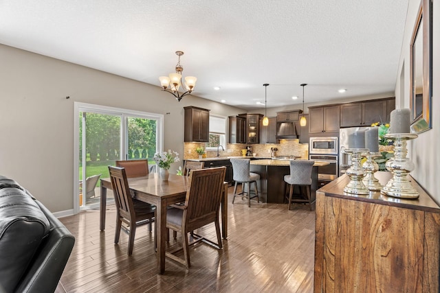 14143 Ailesbury Ave, Rosemount, MN 55068 - dining room featuring recessed lighting, a chandelier, and wood finished floors