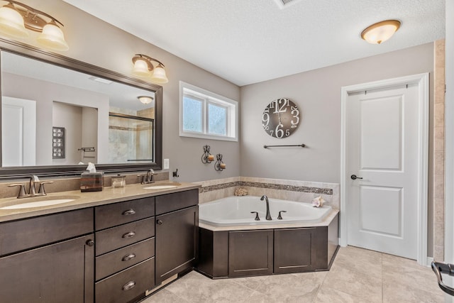 14143 Ailesbury Ave, Rosemount, MN 55068 - bathroom with a stall shower, a garden tub, double vanity, a textured ceiling, and tile patterned floors