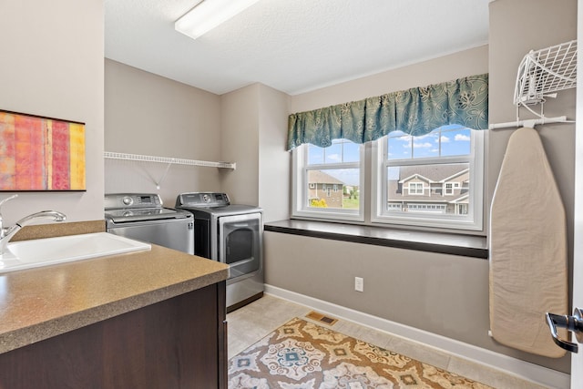 14143 Ailesbury Ave, Rosemount, MN 55068 - laundry area with separate washer and dryer and a textured ceiling