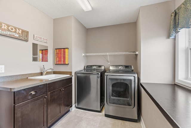 14143 Ailesbury Ave, Rosemount, MN 55068 - washroom featuring independent washer and dryer, cabinet space, light tile patterned floors, and a textured ceiling