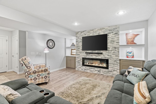 14143 Ailesbury Ave, Rosemount, MN 55068 - living area featuring a large fireplace, light wood-style floors, and recessed lighting