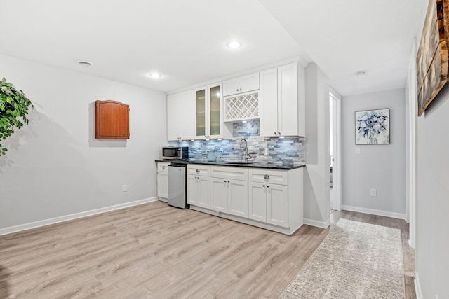 14143 Ailesbury Ave, Rosemount, MN 55068 - kitchen featuring stainless steel appliances, tasteful backsplash, white cabinetry, light wood-style floors, and recessed lighting