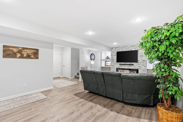 14143 Ailesbury Ave, Rosemount, MN 55068 - living area with wood finished floors, stairway, a stone fireplace, and recessed lighting