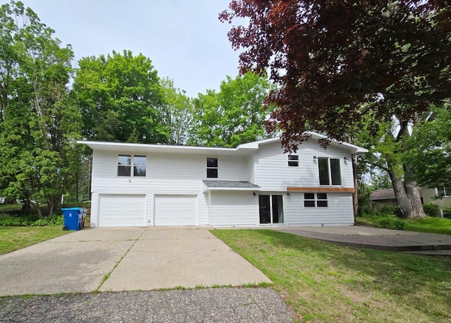 2710 Garden Ln, Mound, MN 55364 - view of front facade with a garage, concrete driveway, and a front lawn