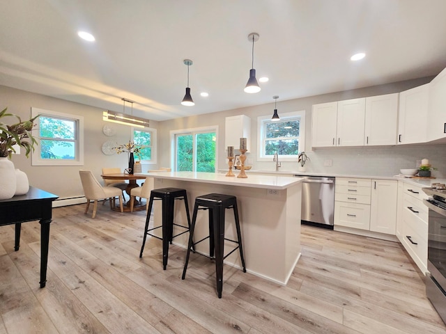 2710 Garden Ln, Mound, MN 55364 - kitchen with stainless steel dishwasher, a kitchen bar, a center island, plenty of natural light, and recessed lighting