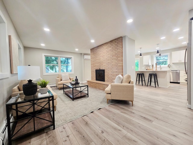 2710 Garden Ln, Mound, MN 55364 - living room with light wood-type flooring, a fireplace, a baseboard radiator, a wall unit AC, and recessed lighting