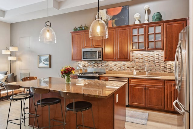 301 Clifton Ave Unit 1K, Minneapolis, MN 55403 - kitchen featuring a sink, appliances with stainless steel finishes, tasteful backsplash, and light stone countertops