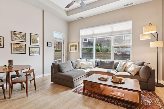 301 Clifton Ave Unit 1K, Minneapolis, MN 55403 - living area with healthy amount of natural light, light wood-type flooring, ceiling fan, and baseboards
