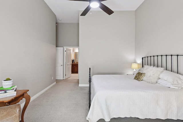 301 Clifton Ave Unit 1K, Minneapolis, MN 55403 - bedroom featuring light colored carpet, baseboards, ensuite bath, a high ceiling, and a ceiling fan