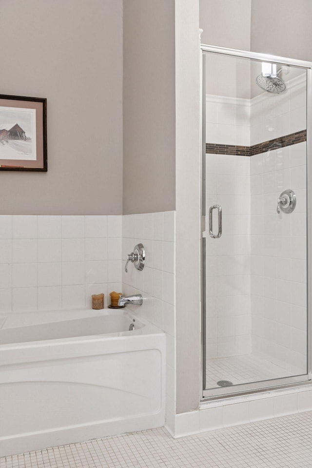 301 Clifton Ave Unit 1K, Minneapolis, MN 55403 - full bathroom featuring a garden tub, a shower stall, and tile patterned floors