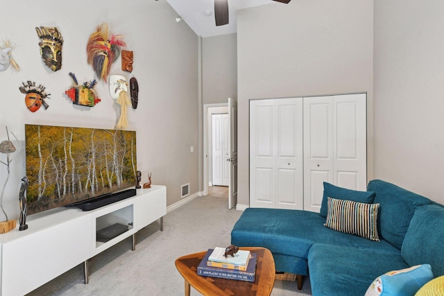 301 Clifton Ave Unit 1K, Minneapolis, MN 55403 - carpeted living area featuring ceiling fan, baseboards, and a high ceiling