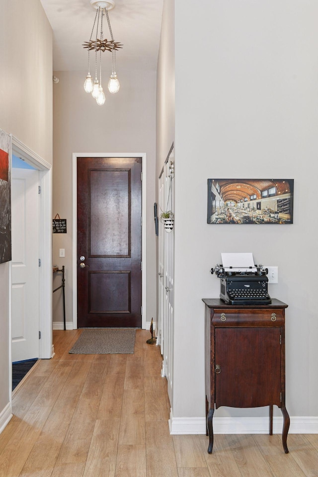 301 Clifton Ave Unit 1K, Minneapolis, MN 55403 - entrance foyer with light wood-style floors, a chandelier, and baseboards