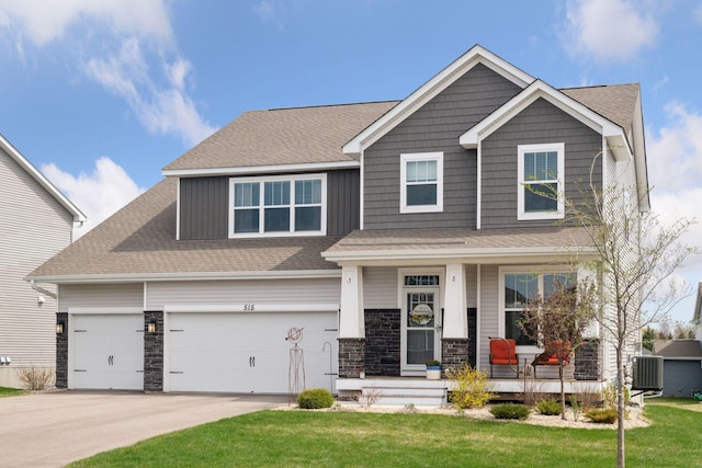 515 Goldenrod Trl, Waconia, MN 55387 - craftsman-style home with covered porch, driveway, a front lawn, and a shingled roof