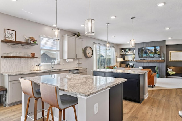 515 Goldenrod Trl, Waconia, MN 55387 - kitchen featuring a kitchen island, a sink, stainless steel dishwasher, open shelves, and recessed lighting