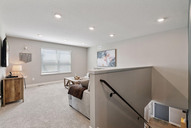 515 Goldenrod Trl, Waconia, MN 55387 - living area with an upstairs landing, baseboards, carpet floors, a textured ceiling, and recessed lighting